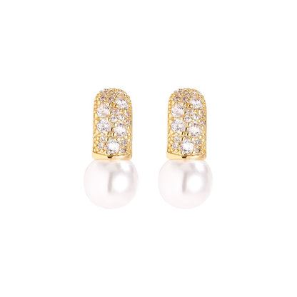 Gold earrings with pearl and sparkling cubic zirconia detail.