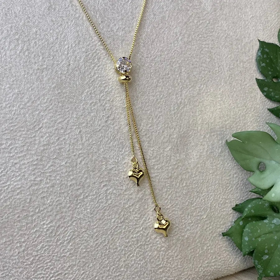 Gold Tie Necklace with Hearts and a Sparkling Stone